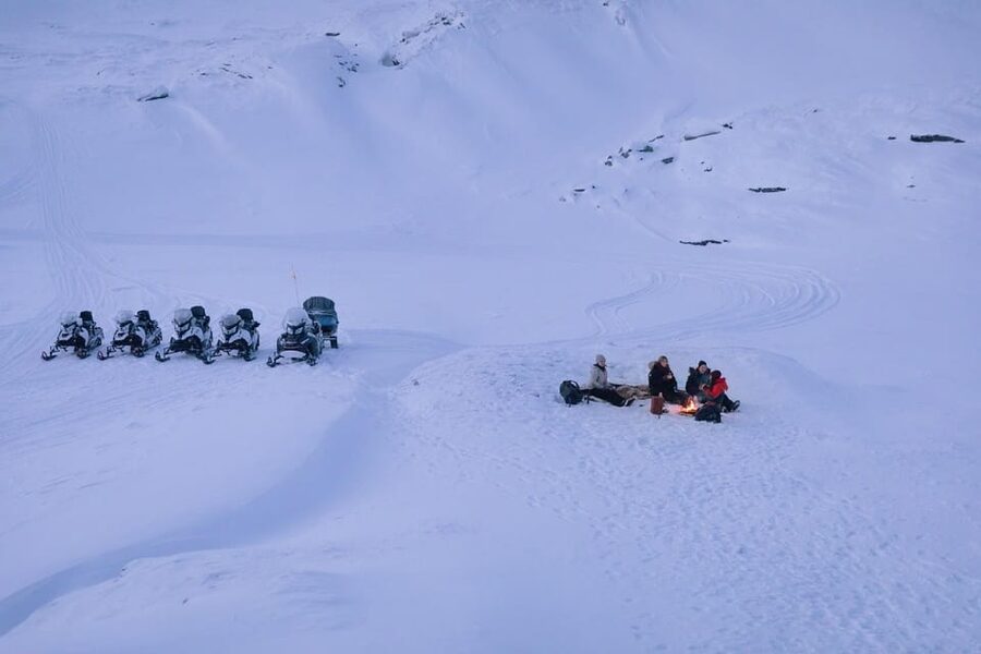 Abisko: Great Outback Snowmobile Tour with Lake Abiskojaure - Getting dressed for a subarctic ride