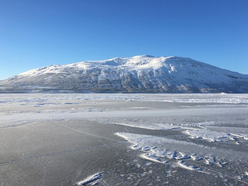 Abisko: Lake Torneträsk Arctic Ice Fishing Trip - Drilling through the ice and learning the basics