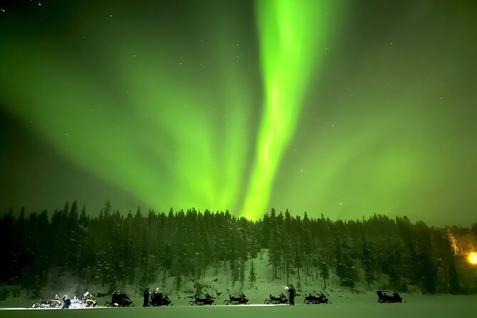 Northern Light snowmobile tour in Kiruna 7:30 pm - Passing the Icehotel on the Torne River